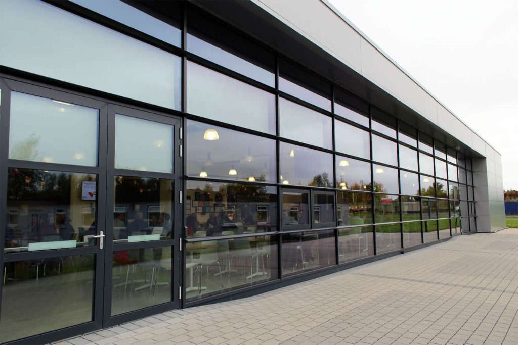 modern glass curtain walling system installed in commercial building Wales