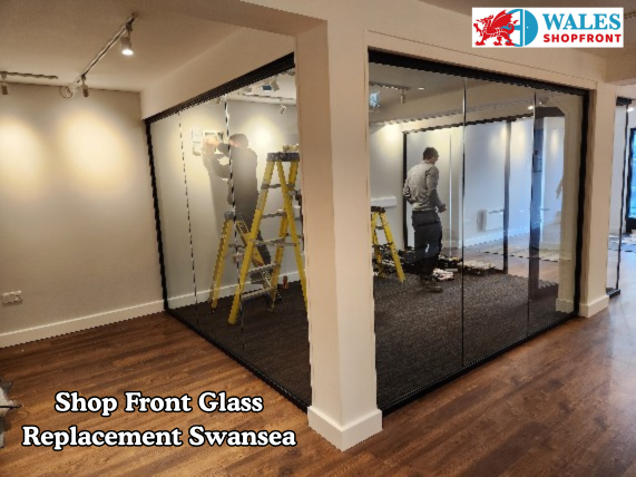 Replacement glass panel being fitted to a commercial shopfront
